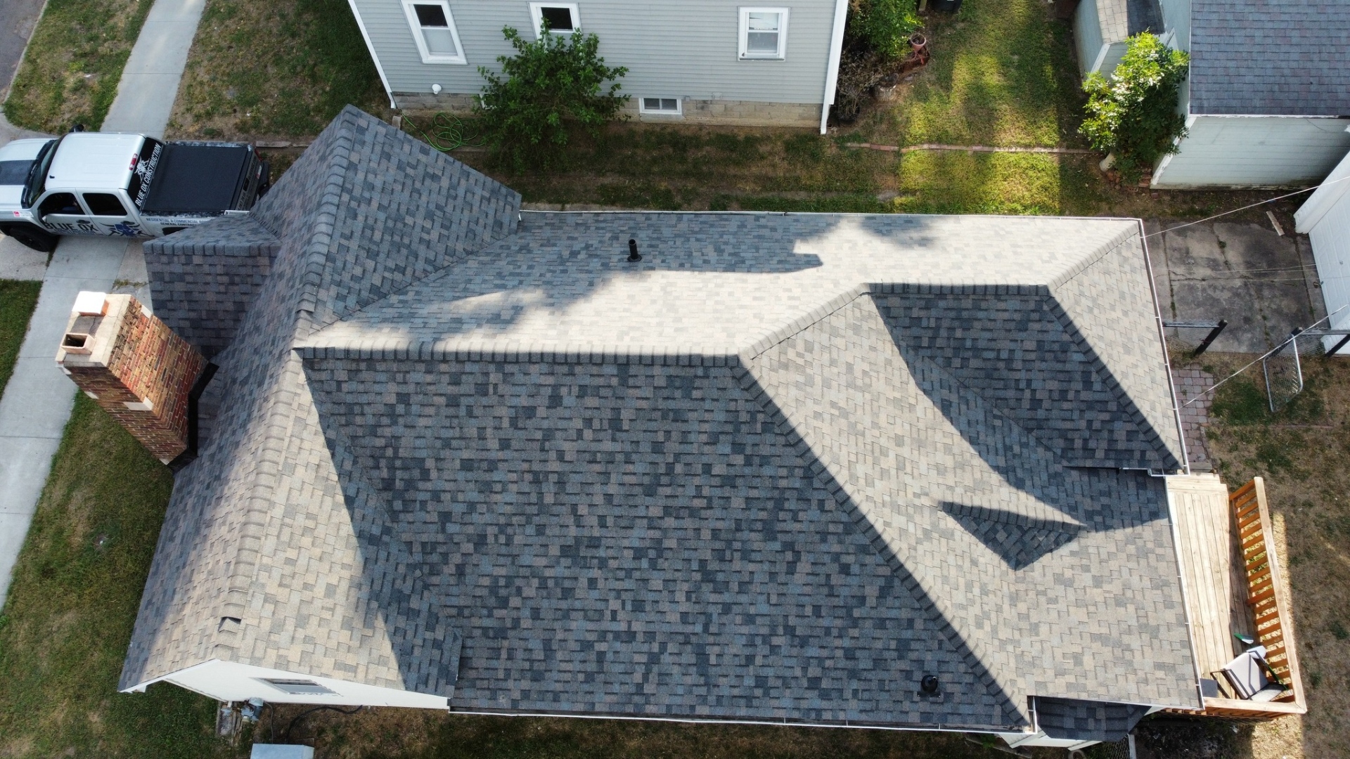 Completed residential roof — Blue Ox truck visible